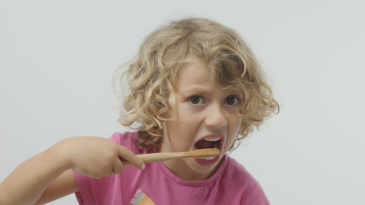 small girl brushing her teeth