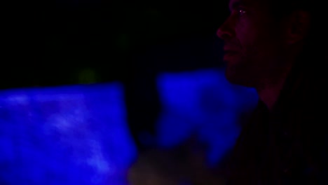 man juggling with light balls during a night party