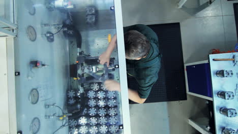 Worker-fixing-metal-detail-in-vice.-Factory-worker-at-industrial-workshop