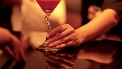 hands meet over a cocktail in bangkok