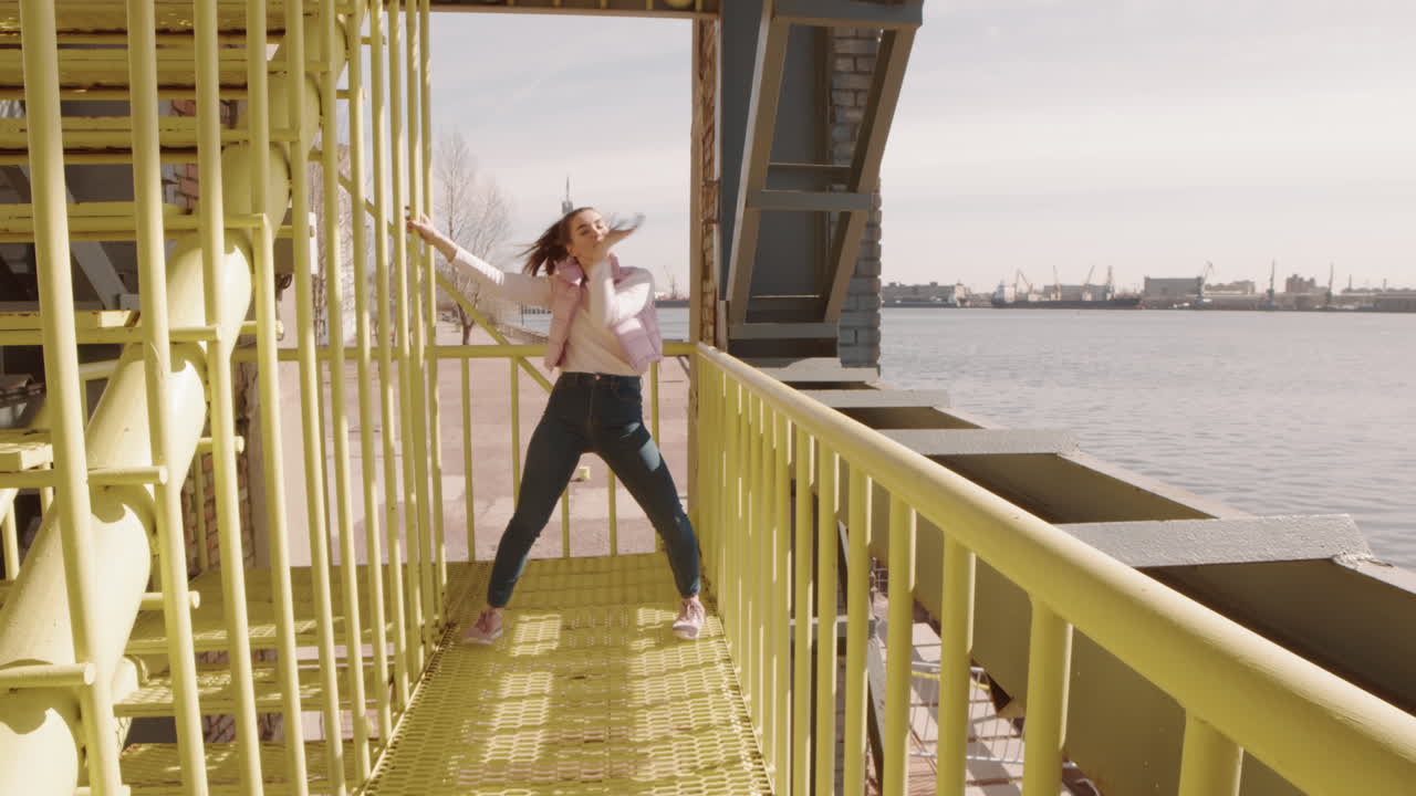 Woman Dancing on Industrial Metal Staircase