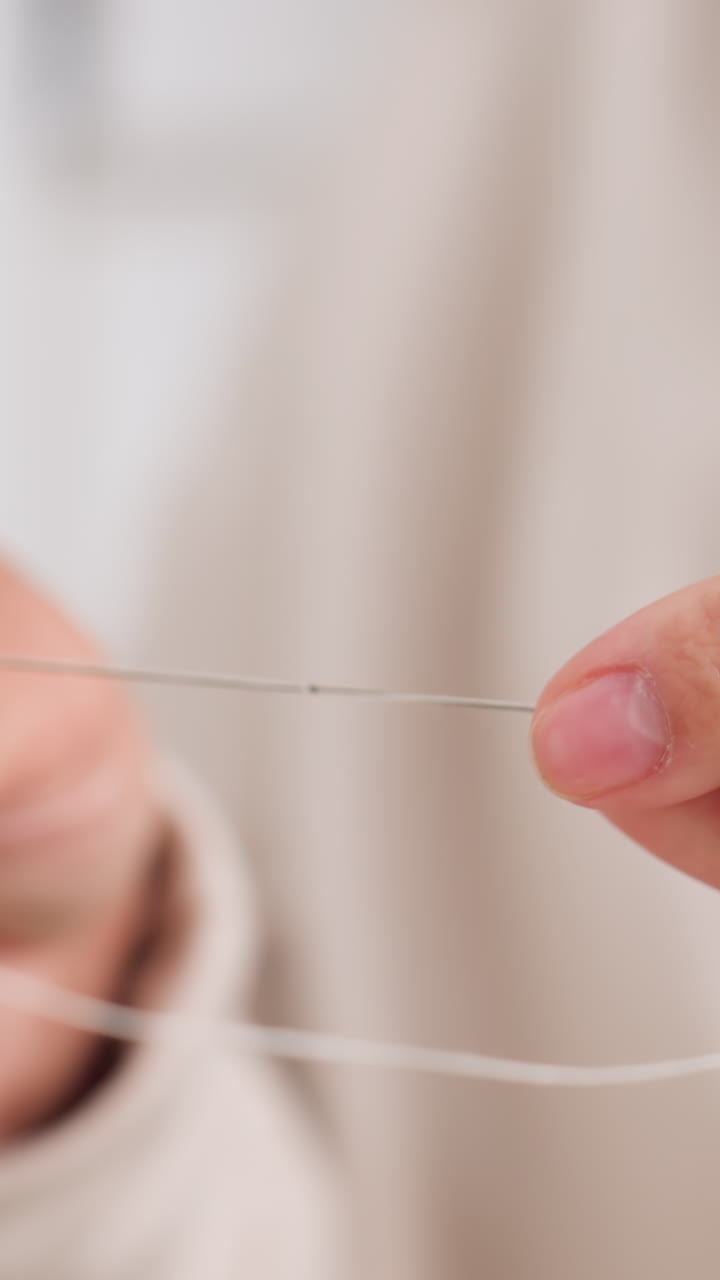 Hands skillfully assemble delicate jewelry, Precision work on intricate wire connections happening, Microlevel focus on handcrafting fine jewelry with steady fingers and gentle illumination