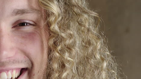 close-up-portrait-of-happy-young-man-smiling-confident-looking-at-camera-enjoying-success-satisfaction-expression-caucasian-male-long-blonde-hairstyle-half-face