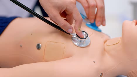 students practice examining a patient on a medical doll