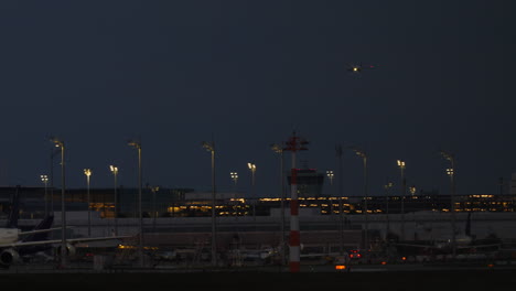 airplane landing at night at an airport