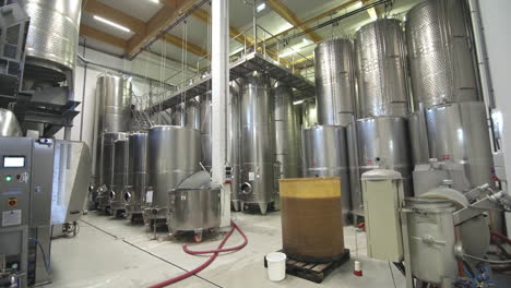 large tanks in warehouse at winery, wide shot