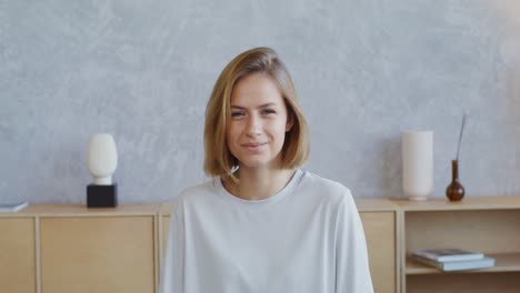 young woman smiling in a living room