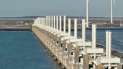 Aerial-shot-of-traffic-on-the-Eastern-Scheldt-storm-surge-barrier-in-Zeeland,-the-Netherlands,-on-a-beautiful-sunny-day