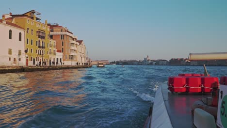 shot from a water taxi of the canals of venice on a sunny day