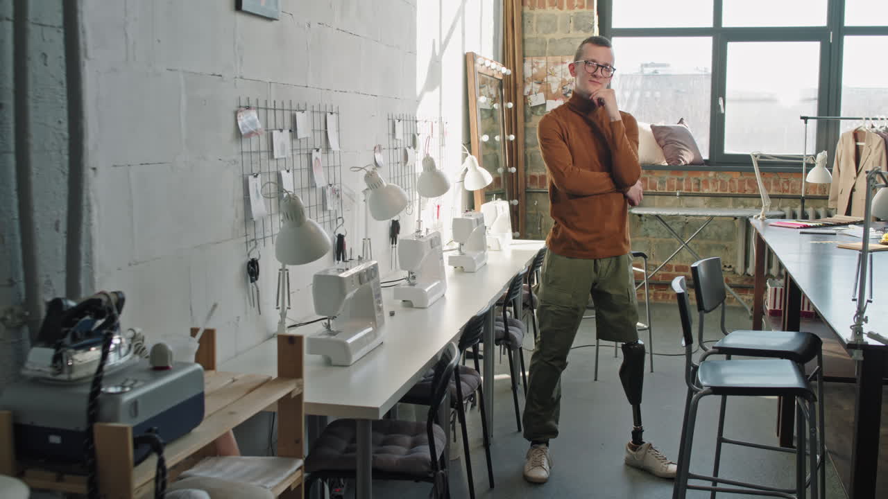 Fashion Designer with Artificial Leg Posing in Workplace