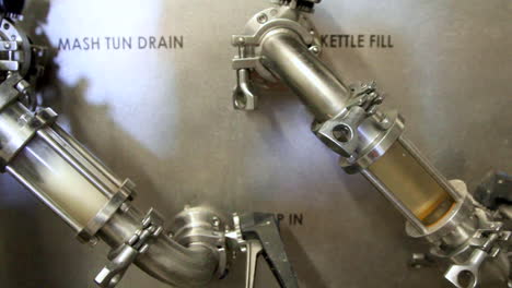 Close-up-shot-showing-fresh-beer-in-kettle-tank-producing-in-beer-factory