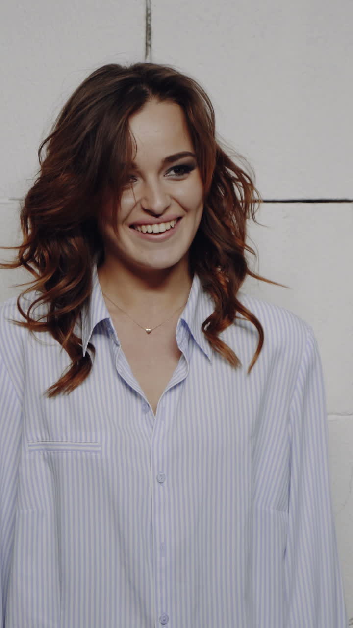 Portrait of a young beautiful brunette with a beautiful make up Vertical video