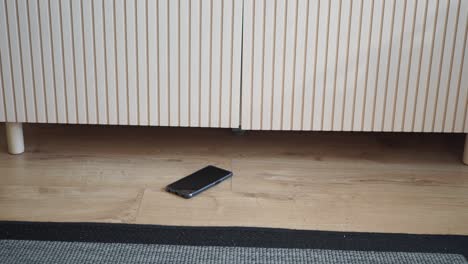 phone on the floor near a cabinet