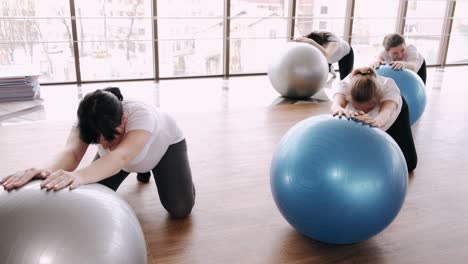 european women are doing renatal exercises with exercise balls and instructor