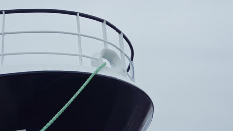 close up of a ships starboard side, with a rope from it