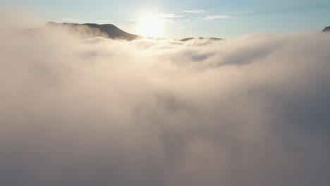 sunrise or sunset over mountains in clouds