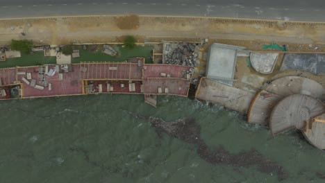 low-level sea storms biperjoy waves hitting the seashore, buildings on the along the coastline