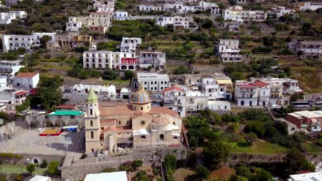 Saint-Gennaro-church-of-Praiano-Italy,-with-colorful-Talavera-dome,-Aerial-circling-wide-shot