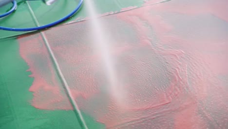 slow motion video 4k closeup red fluid preparation high-pressure ship deck floors from a pressure washer