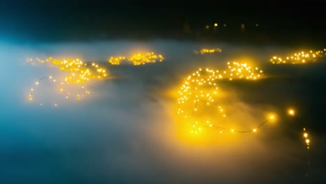 a captivating display of twinkling lights glowing through a mystical fog, creating an enchanting atmosphere of illumination and wonder in the darkness