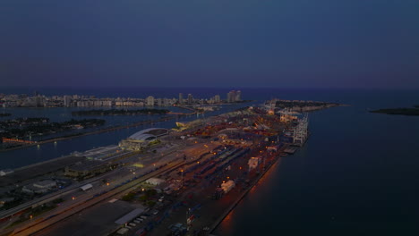 Evening-aerial-view-of-Dodge-Island-in-sea-bay.-Overseas-containers-in-cargo-harbour-after-sunset.-Miami,-USA