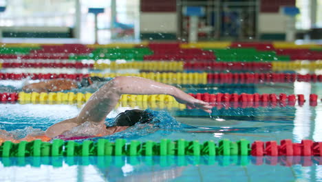 two female swimmers during a race in the freestyle swim discipline, slow motion