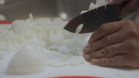 Woman-chopping-white-onions-in-the-kitchen,-120fps