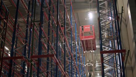 big and modern warehouse under construction, featuring metal shelving and other industrial equipment.