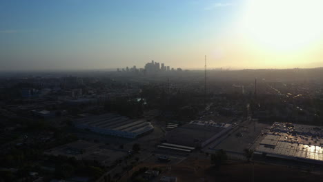 drone pulling back during a fantastic sunset with downtown los angeles skyline in the background