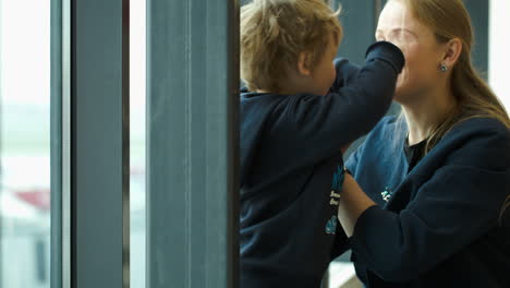 Mother-and-son-playing-together-making-birds-with-their-hands