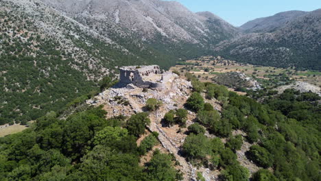 Turkish-castle-ruins-in-the-Leuka-Ori-mountains-aerial-view-reversing-Improu-gorge-in-the-Askifou-plateau,-Crete