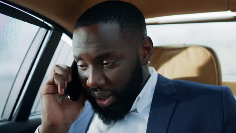 Tired-african-american-man-talking-mobile-phone-in-vehicle.-Happy-man-face