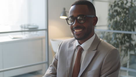 portrait of happy african american businessman in office