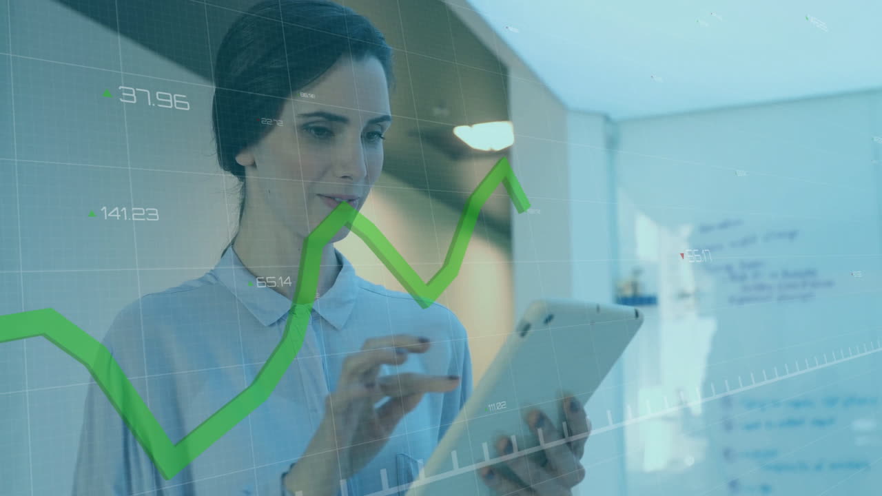 Using tablet, businesswoman analyzing financial graphs overlay in office setting