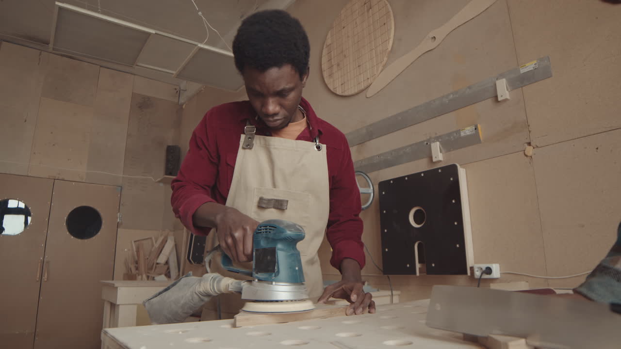 African American Male Carpenter Working in Carpentry Workshop