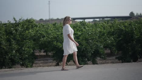 woman walking through trees