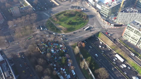 homeless migrants in paris aerial shot ring road traffic pollution