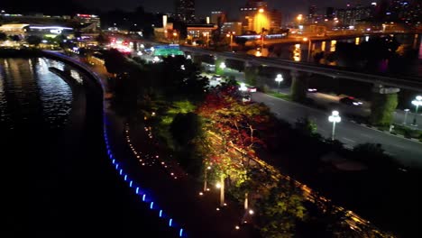 cinematic aerial view of cars driving on sentosa boardwalk road at night, singapore