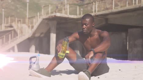 Animation-of-glowing-lights-over-an-exercising-african-american-man-drinking-water