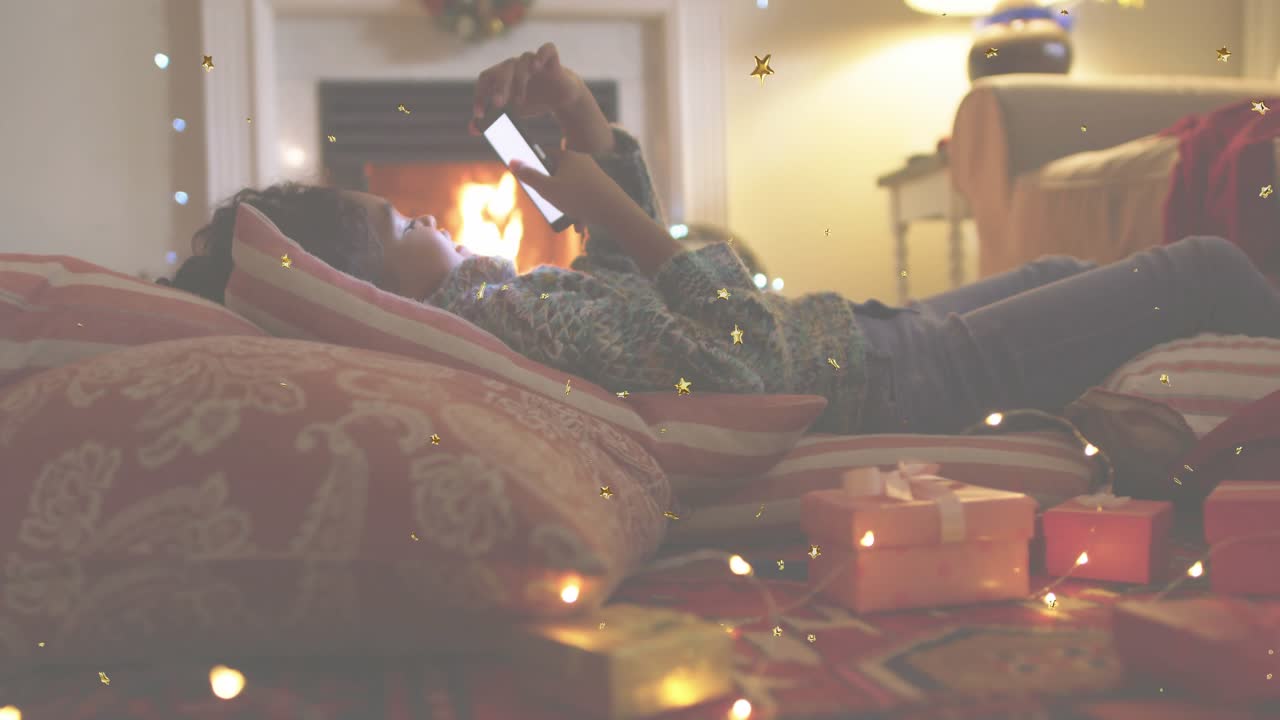 Preteen girl tapping smartphone scrolling holiday messages in tech app with floating star particles