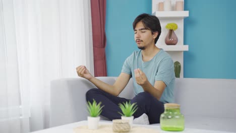 man doing yoga outside in front of the window.