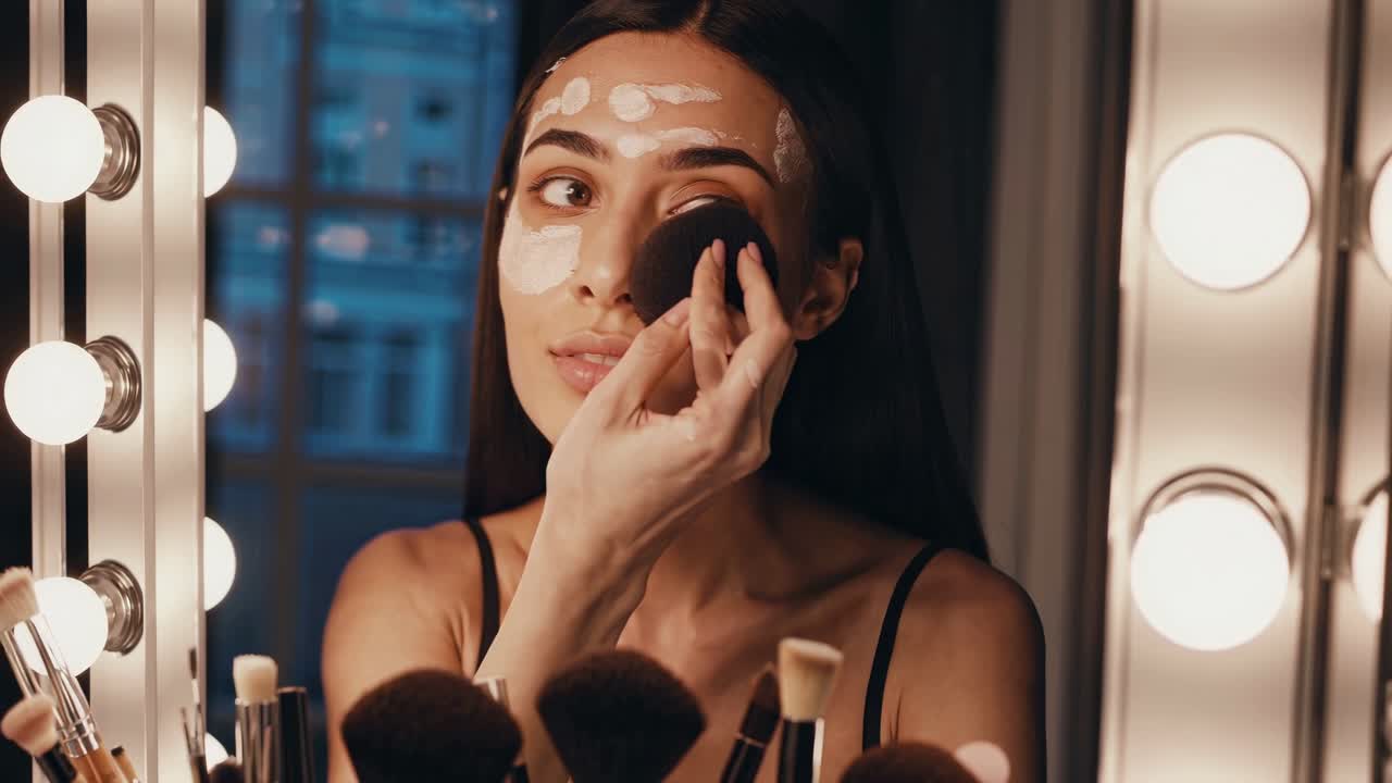 Woman applying facial mask in front of a mirror