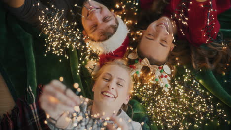 women and man with glowing christmas lights