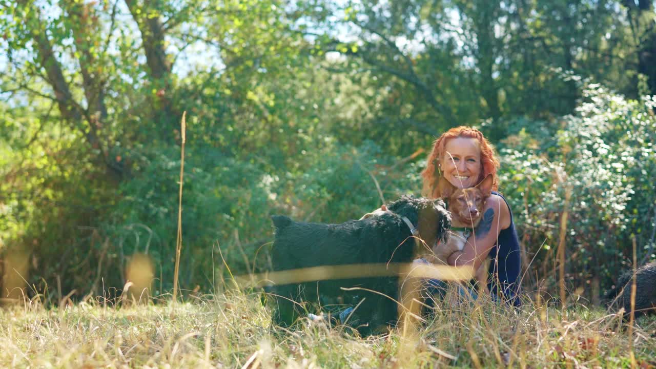 Woman and her two dogs enjoying time outdoors