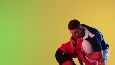 Diverse-male-rugby-players-with-rugby-ball-playing-over-yellow-lighting