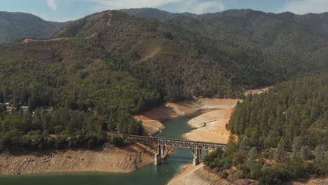 Aerial-view-of-bridge-over-Shasta-Lake-in-Northern-California-low-water-levels-during-drought