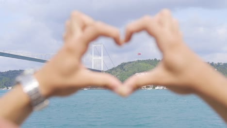 the turkish flag and the bridge in the bosphorus are in the heart.