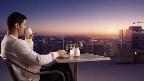 man enjoying a drink on a balcony with a city sunset view