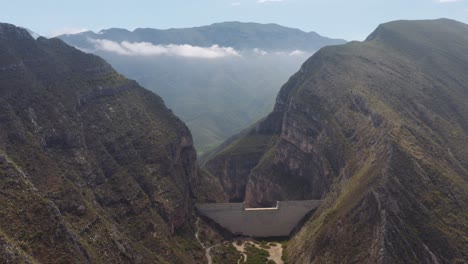 wide, high aerial view of dam for flood and erosion control in mountains of nuevo leon, mexico near monterrey