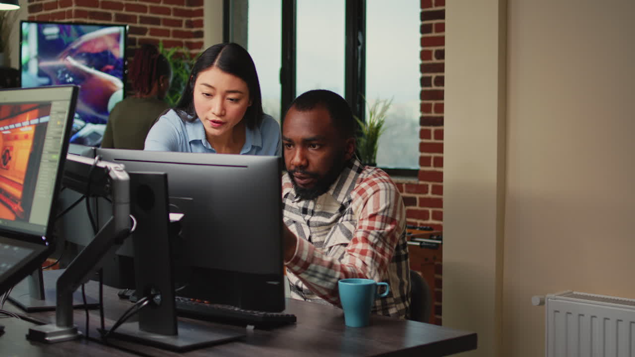 Creative agency employees using computers to develop new graphics interface